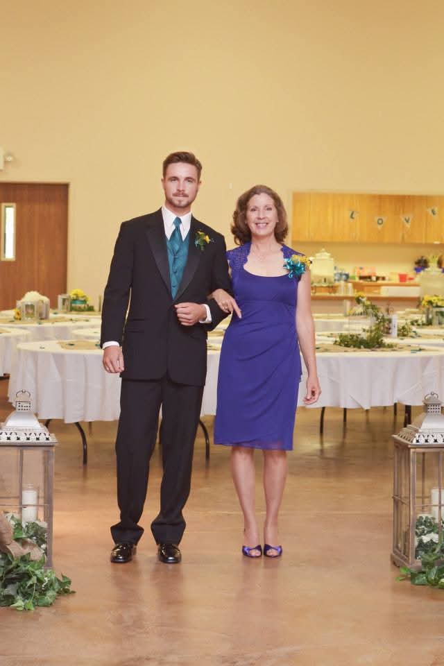 Walking her son down the aisle